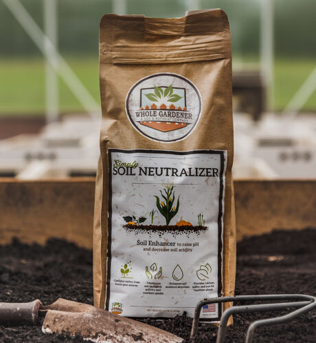 bag of simply soil neutralizer next to soil and garden trowel